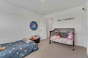 Bedroom featuring carpet floors and baseboards