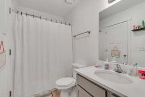 Bathroom featuring vanity and curtained shower
