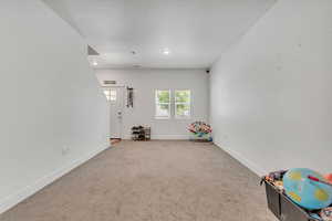 Recreation room with carpet flooring, recessed lighting, and a textured ceiling