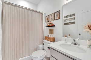 Bathroom featuring vanity and curtained shower
