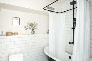 Bathroom featuring tile walls