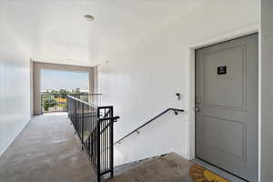 View of exterior entry with a balcony