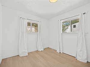 Empty room with light wood finished floors and baseboards