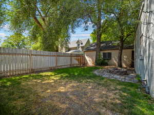 Fenced backyard featuring an outdoor fire pit
