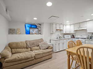Living area featuring light wood-type flooring and recessed lighting