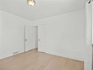 Empty room with wood finished floors and baseboards