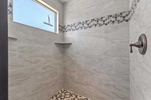 Full bathroom featuring a tile shower