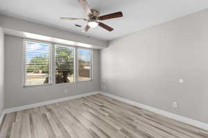Spare room featuring light wood-style flooring and ceiling fan
