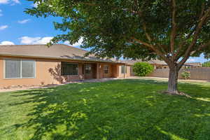Rear view of house with stucco siding, a tile roof, and a patio