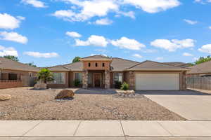 Prairie-style home with stone siding, concrete driveway, an attached garage, stucco siding, and a tiled roof