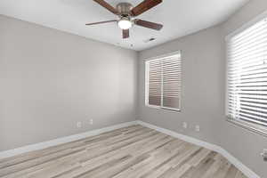 Spare room featuring light wood-style flooring and a ceiling fan