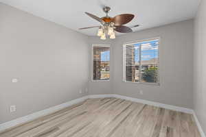 Spare room featuring light wood-style floors and ceiling fan