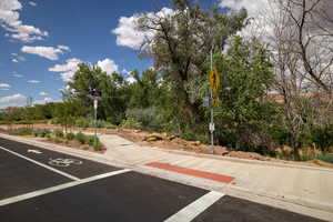 View of car parking featuring view of scattered trees