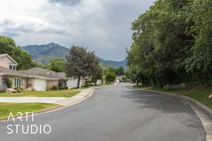 View of asphalt road with a mountain view and curbs