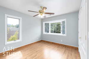 Spare room featuring wood finished floors and a ceiling fan