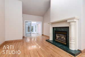 Unfurnished living room featuring a fireplace and wood finished floors