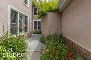 Doorway to property featuring stucco siding