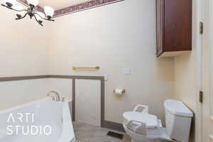 Bathroom featuring a chandelier and a garden tub