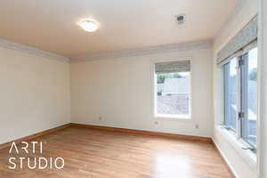 Spare room with wood finished floors and baseboards