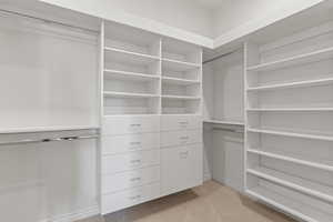 Walk in closet with light carpet