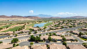 Aerial perspective of suburban area with a water and mountain view and a golf course