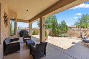 Fenced backyard with a patio area, outdoor lounge area, and grilling area