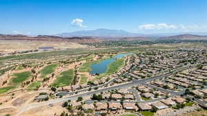 Aerial perspective of suburban area with a water and mountain view and a local golf course