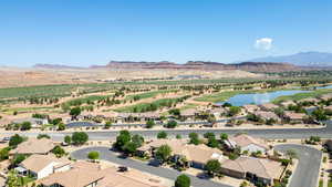 Aerial view of residential area with a water and mountain view and a local golf course