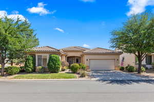 Mediterranean / spanish-style home featuring an attached garage, stucco siding, driveway, and a tiled roof