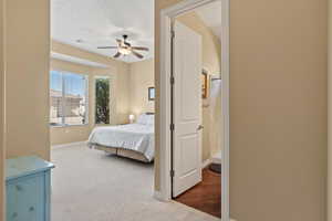 Carpeted bedroom with baseboards and a ceiling fan