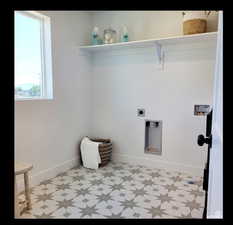 Laundry area featuring light floors, hookup for a washing machine, and electric dryer hookup