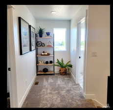 Hallway featuring carpet floors and a textured ceiling