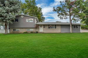 Tri-level home featuring a front yard