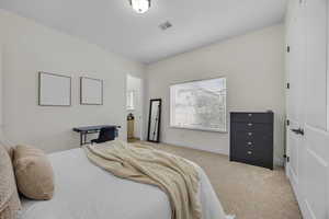 Bedroom featuring light colored carpet and baseboards