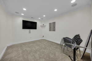 Unfurnished room featuring crown molding, recessed lighting, carpet floors, and electric panel