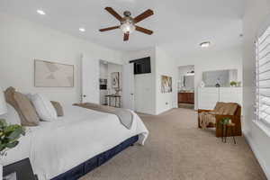 Bedroom with light colored carpet, ensuite bath, ceiling fan, and recessed lighting