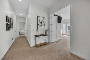 Corridor with carpet and recessed lighting