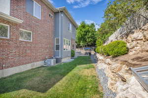 View of grassy yard featuring a patio area