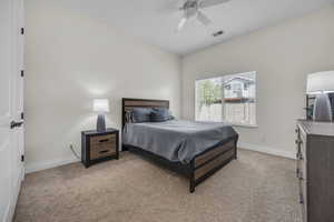Bedroom featuring light colored carpet and ceiling fan