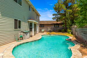 View of pool with a fenced backyard and a patio area