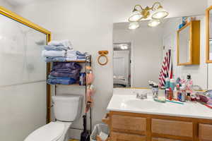 Ensuite bathroom with a stall shower and vanity