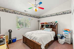 Bedroom with light carpet, vaulted ceiling, and ceiling fan