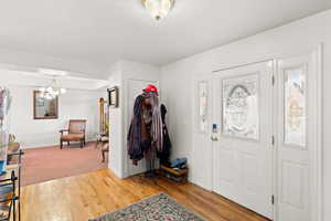 Foyer entrance featuring a chandelier and light wood-style floors