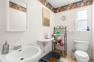 Bathroom with a sink and tile patterned floors