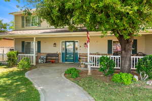View of front of house featuring a porch and brick siding