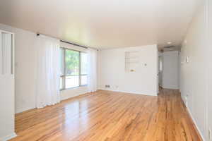 Refinished hardwood flooring and new paint throughout