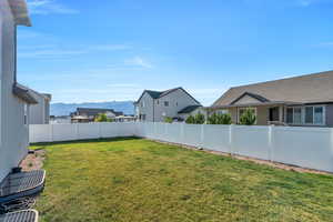 Fenced backyard featuring a mountain view