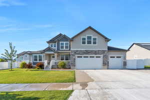 Craftsman inspired home featuring stone siding, concrete driveway, stucco siding, and an attached garage