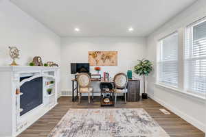 Office space with wood finished floors and recessed lighting