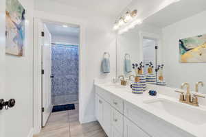 Bathroom featuring double vanity and tile patterned flooring